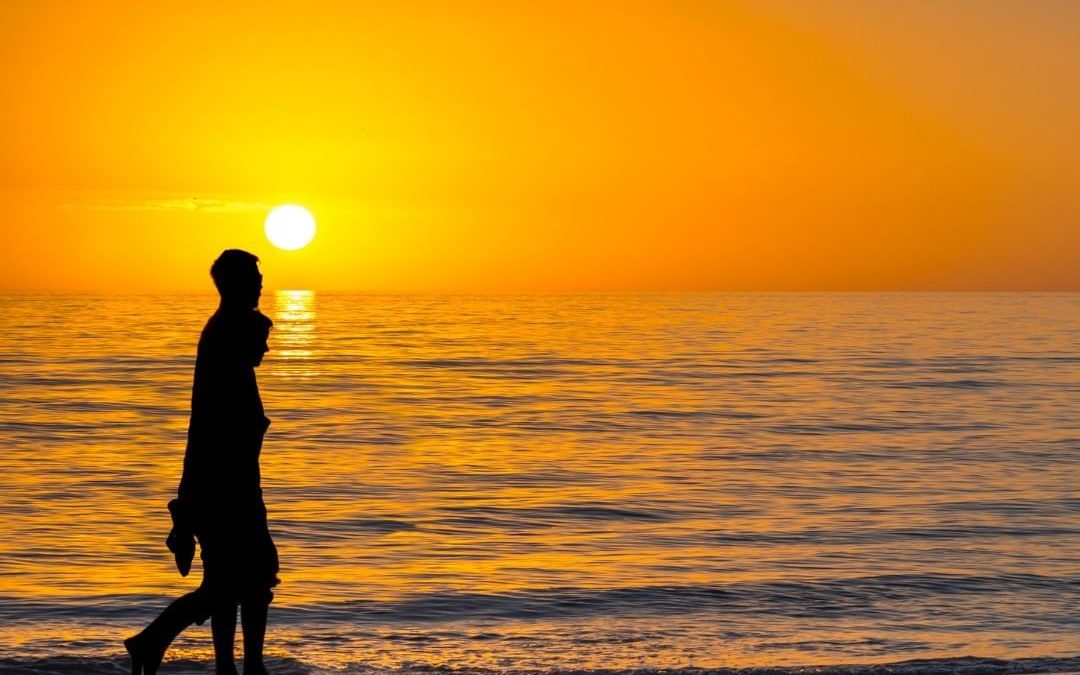 A silhouette of a couple walking on the beach? Check.

Calm ocean waters in the …